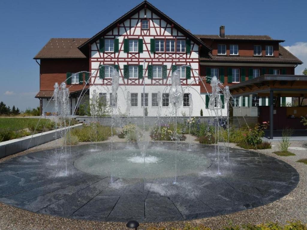 a water fountain in front of a building at Apartment Sunnebad Sternenberg by Interhome in Sternenberg