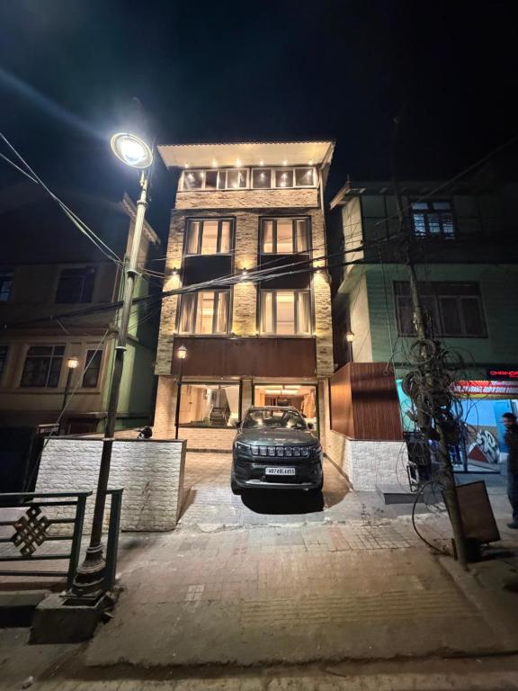 a car parked in front of a building at night at Royale Serenity in Gangtok