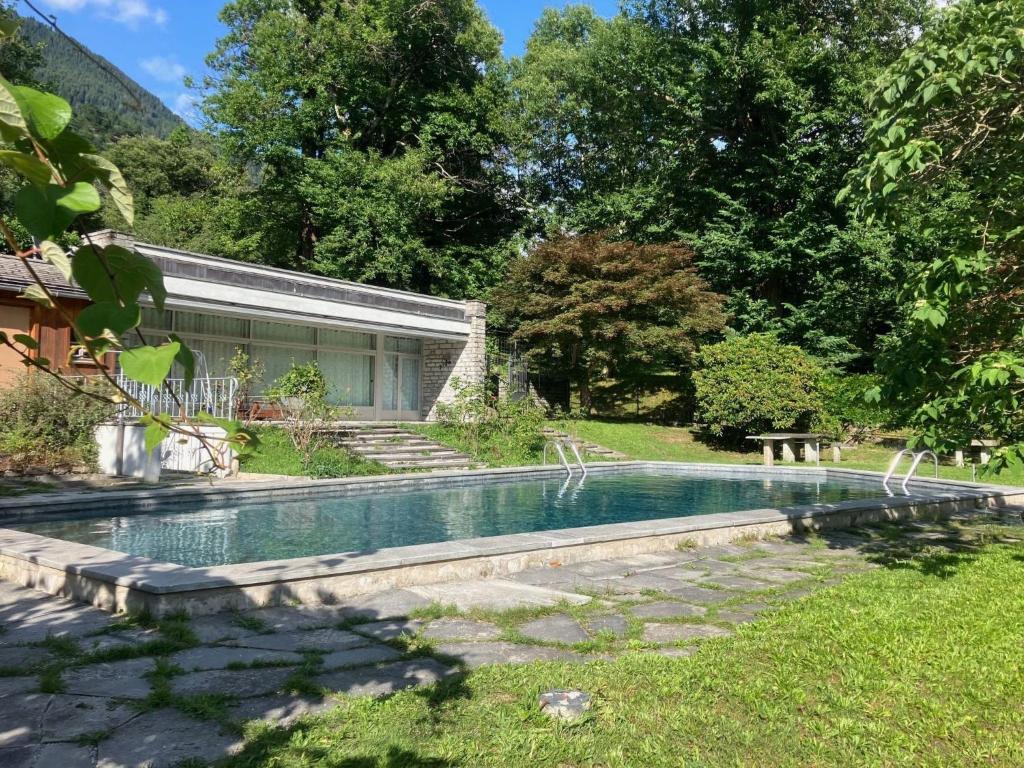 a swimming pool in the yard of a house at Apartment Pavillon Castagneto by Interhome in Castasegna