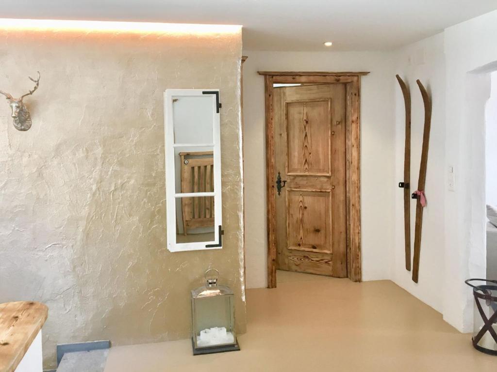 a room with a mirror and a door at Apartment Alpenchic SpycherHus by Interhome in Klosters