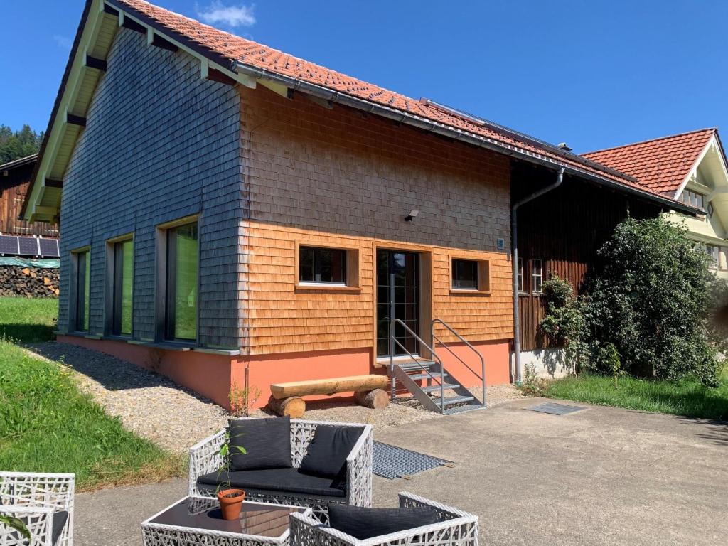 a house with a porch and a couch in front of it at Apartment nirkwerk by Interhome in Schönengrund