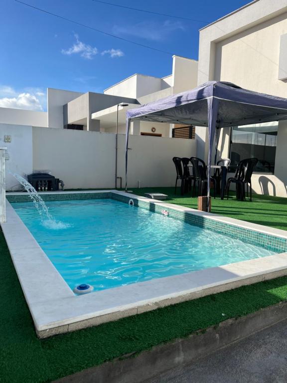 a swimming pool in the backyard of a house at CASA MARECHAL FRANCÊs in Marechal Deodoro