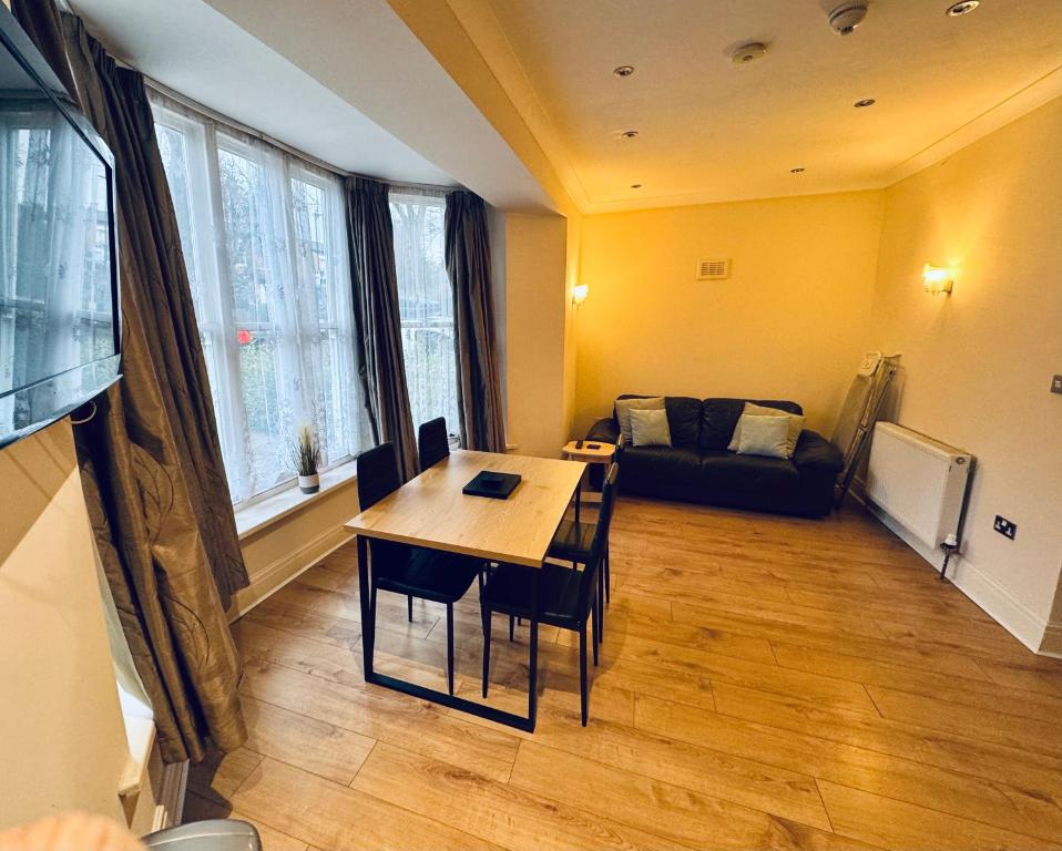 a living room with a table and a couch at Nether Edge Apartments in Sheffield