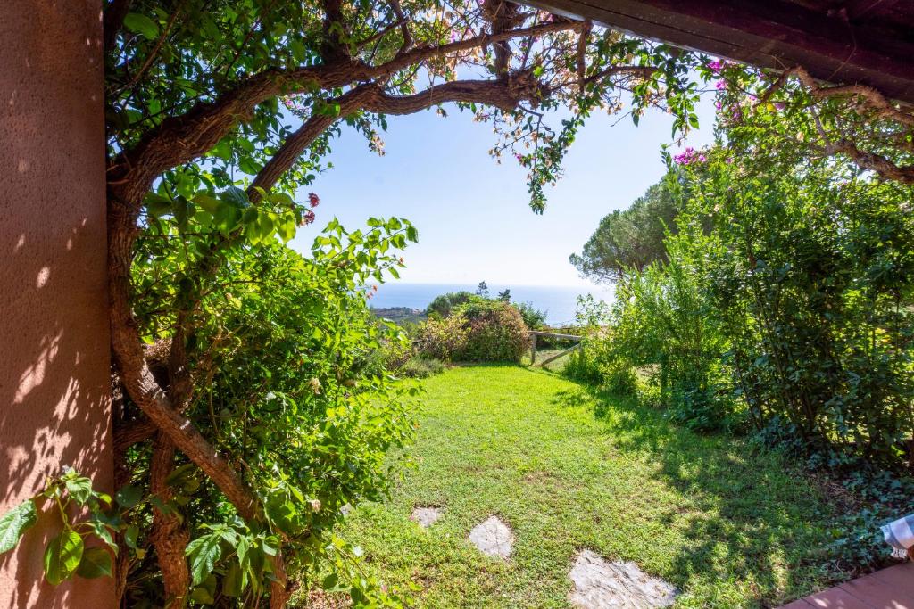 a view of a garden through a tree archway at Asfodeli Holiday Home in Monte Nai