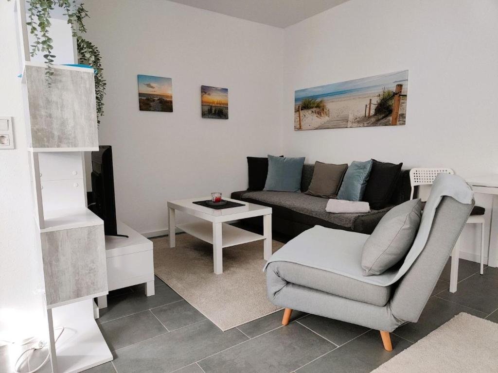 a living room with a couch and a table at Apartment Studio-Wohnung Heide2 mit Terrasse by Interhome in Walsrode