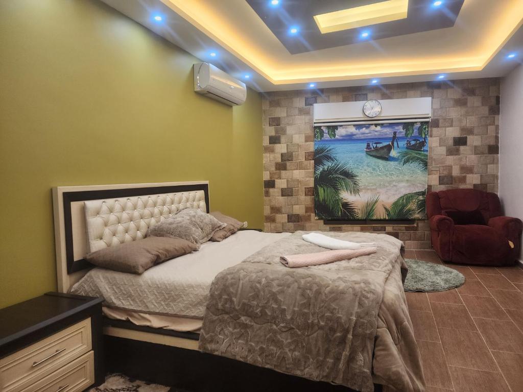 a bedroom with a bed and a chair in it at A big Family nice sunset flat in Amman