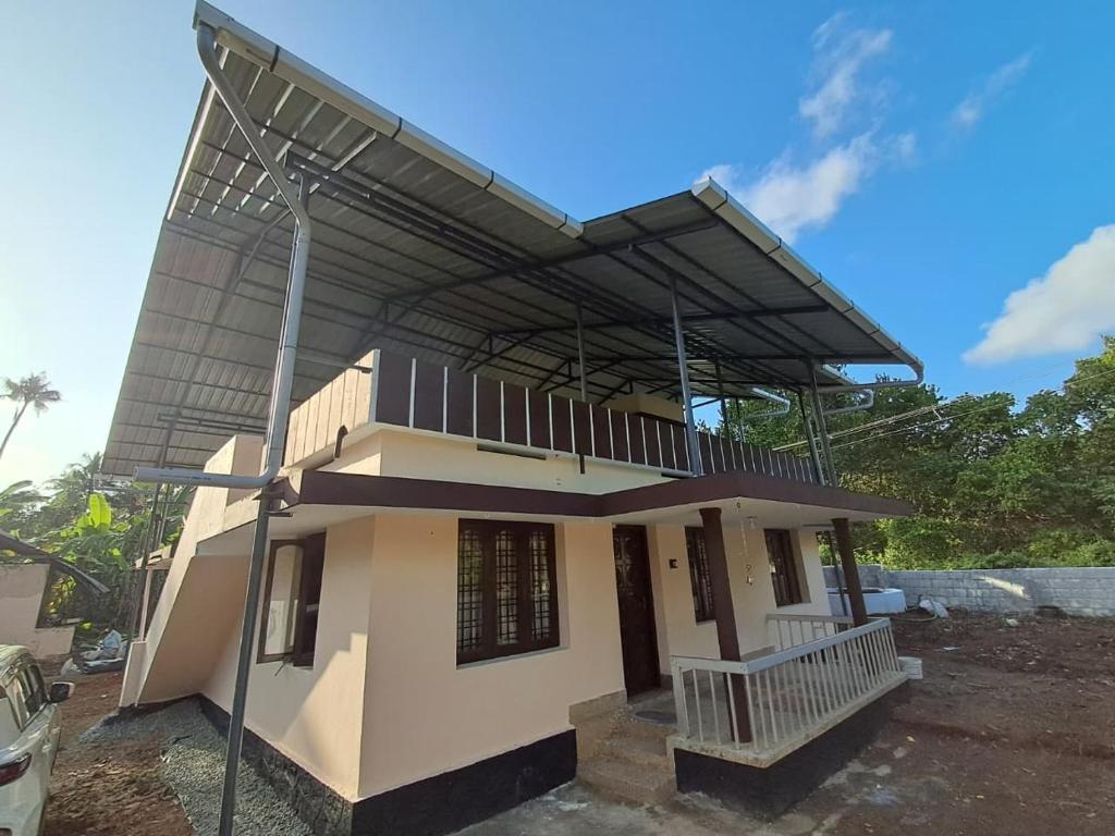 a small house with awning on top of it at A-Kutty in Irinjālakuda