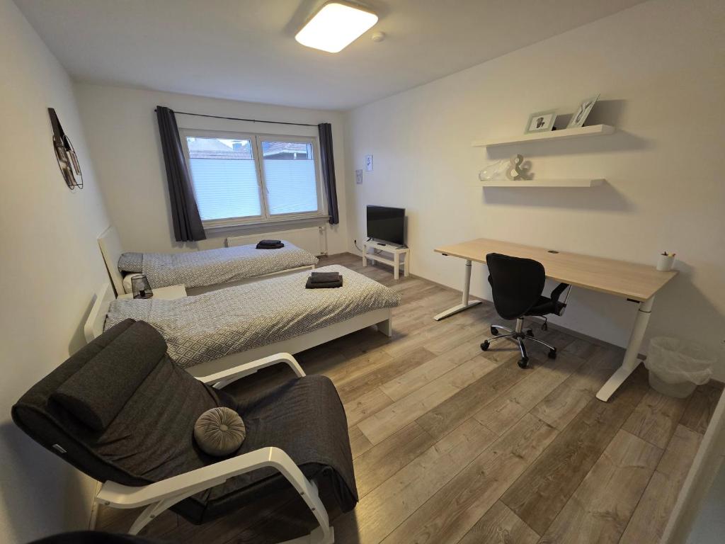 a bedroom with a bed and a desk and a desk at Einzelzimmer für bis zu 2 Personen - 4 OG in Duisburg