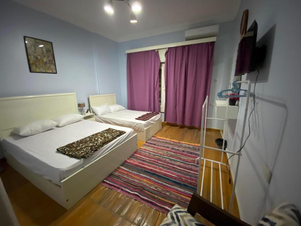 a small room with a bed and a couch at Menna's home in Cairo