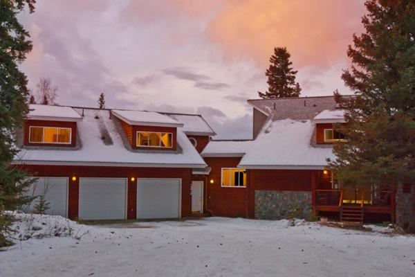 a house with snow on the front of it at Moosedance 2 bedroom suite, beautiful views in Anchorage