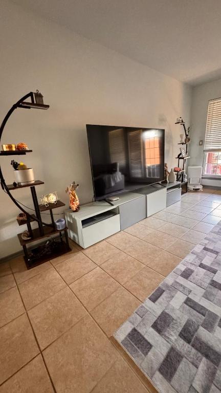 a living room with a large flat screen tv at Andrei's nest in Oklahoma City