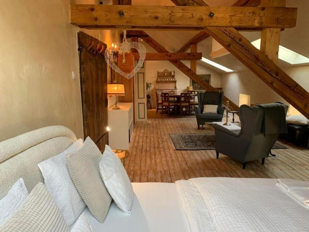 a bedroom with a bed and a living room at Apartment AMARCORD Loft by Interhome in Biasca
