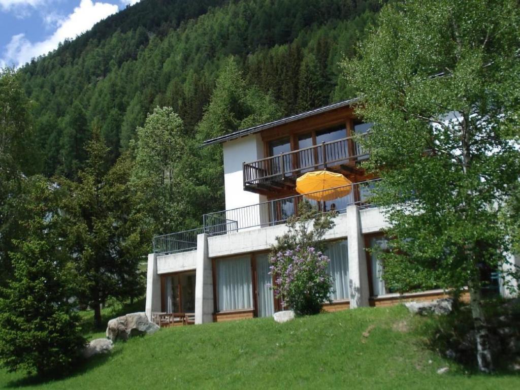 a house with an umbrella on top of a hill at Apartment Studio by Interhome in Bever
