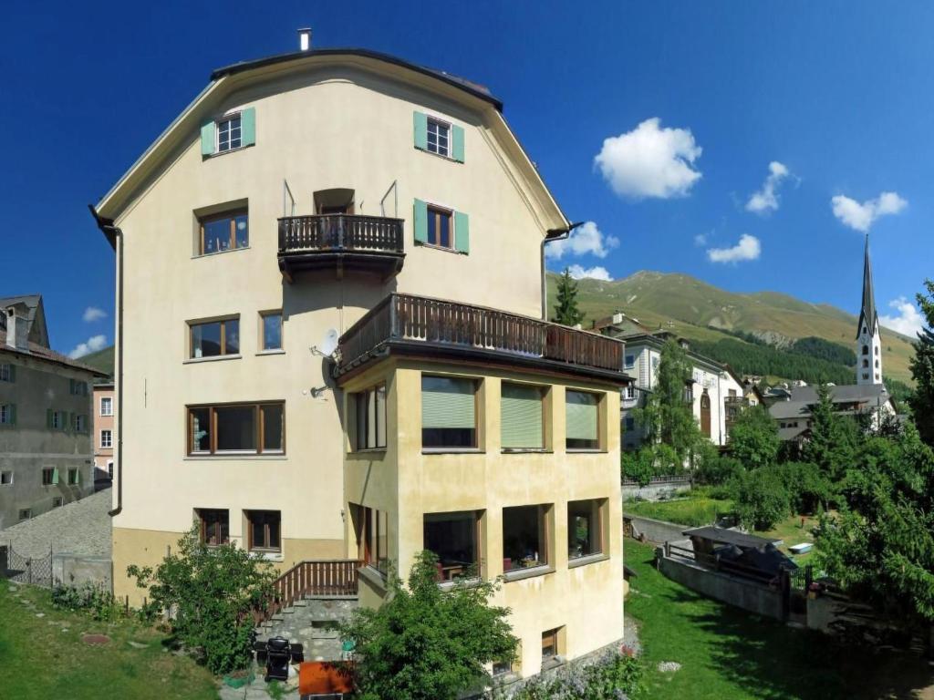 a building with a balcony on top of it at Apartment Chesa Müller by Interhome in Zuoz