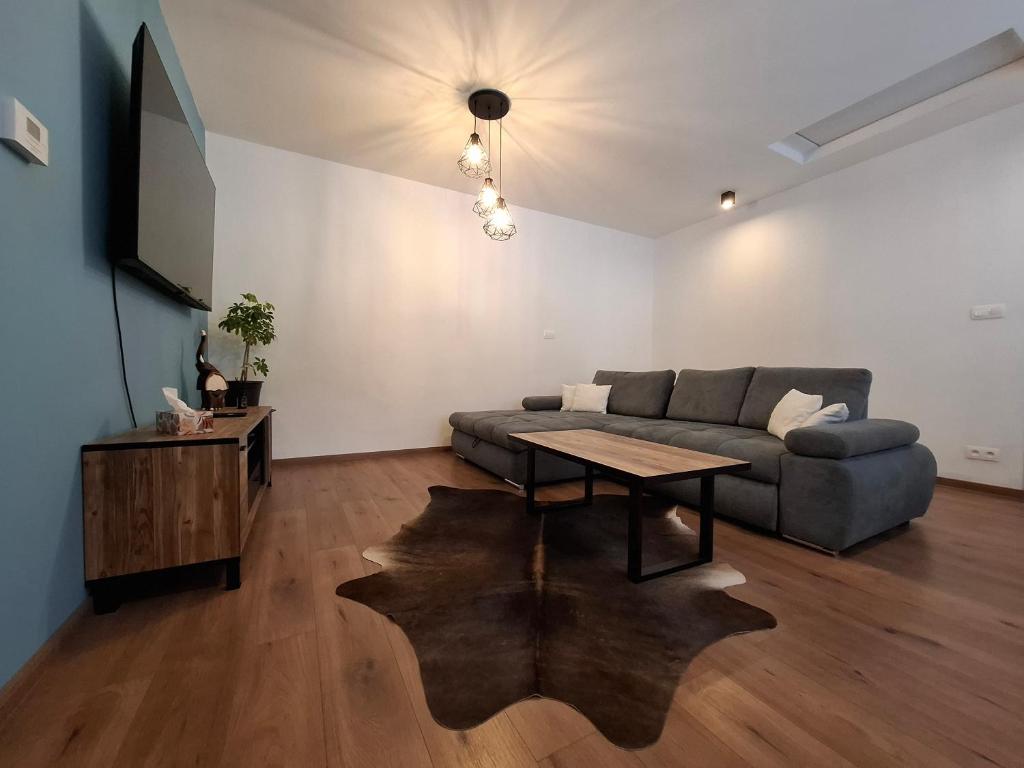 a living room with a couch and a table at Chata pod vŕškami Važca in Važec