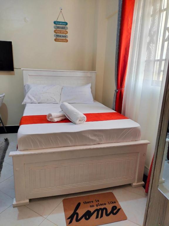 a bedroom with a bed with towels on it at Khalisee homes studio apartment 4 in Voi