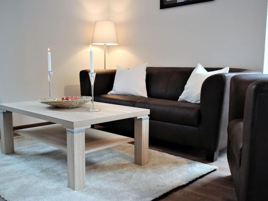 a living room with a couch and a coffee table at Apartment Heidestrauch by Interhome in Thülsfeld
