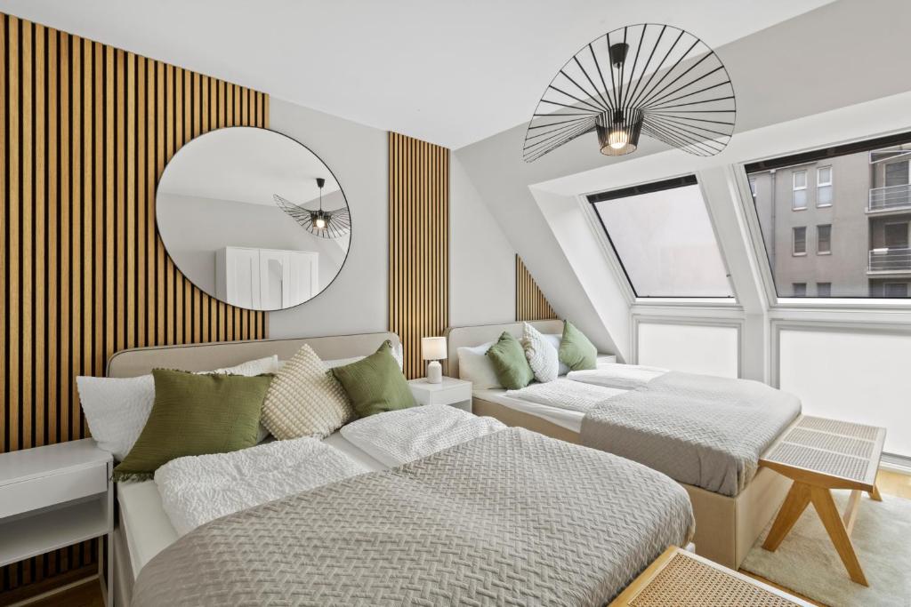 a bedroom with two beds and a mirror at U1 Metro Nearby - 1-BR - fast Wi-Fi in Vienna