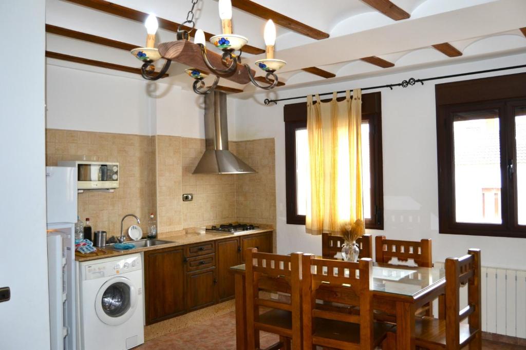 a kitchen with a table and chairs in a kitchen at Casas rurales la Codorniz in Almaciles