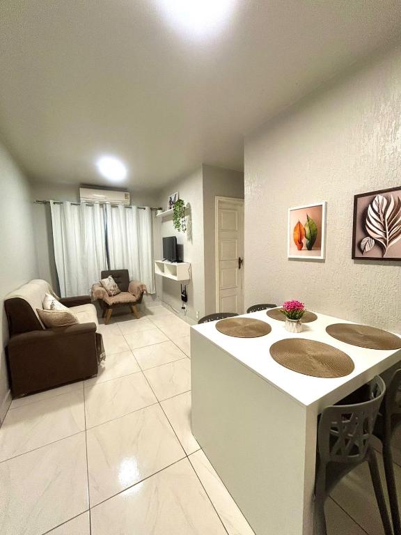 a living room with a couch and a table at Apartamento CONFORT 2Q in Rio Branco