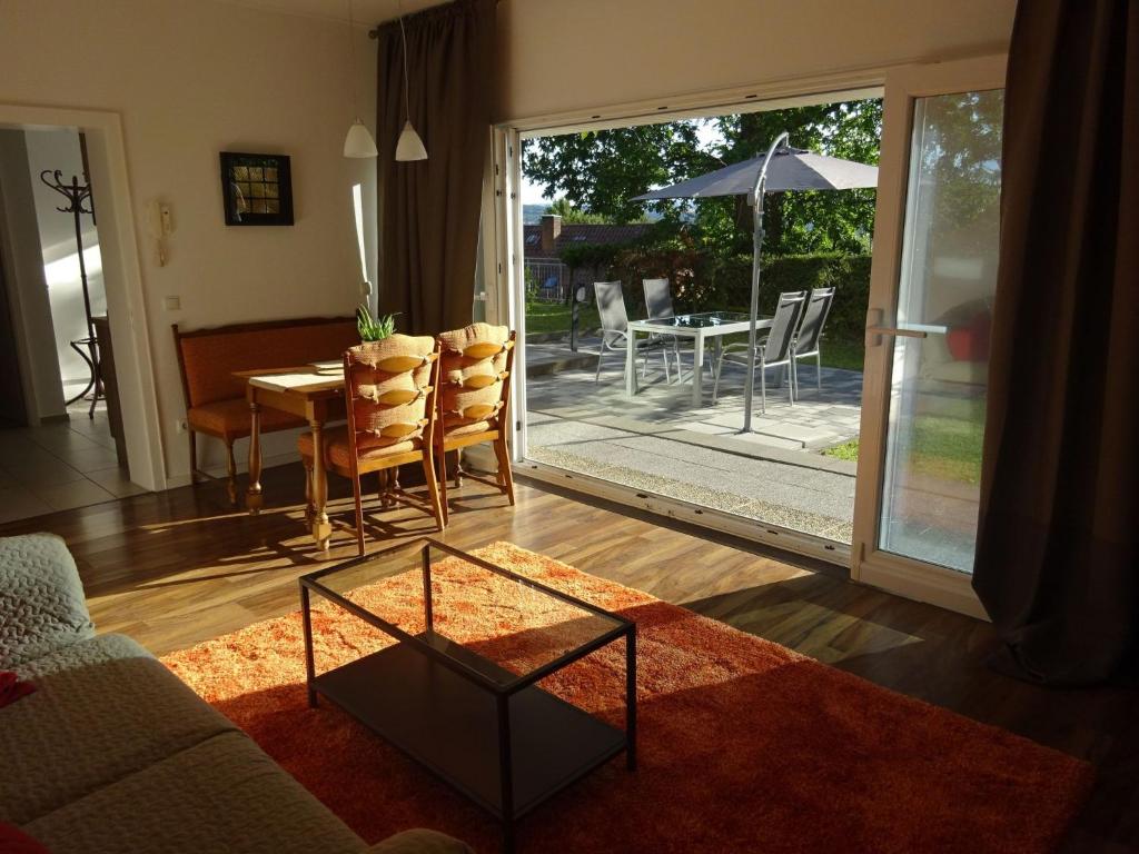 a living room with a couch and a table and chairs at Apartment Rheintalblick 2 by Interhome in Linz am Rhein