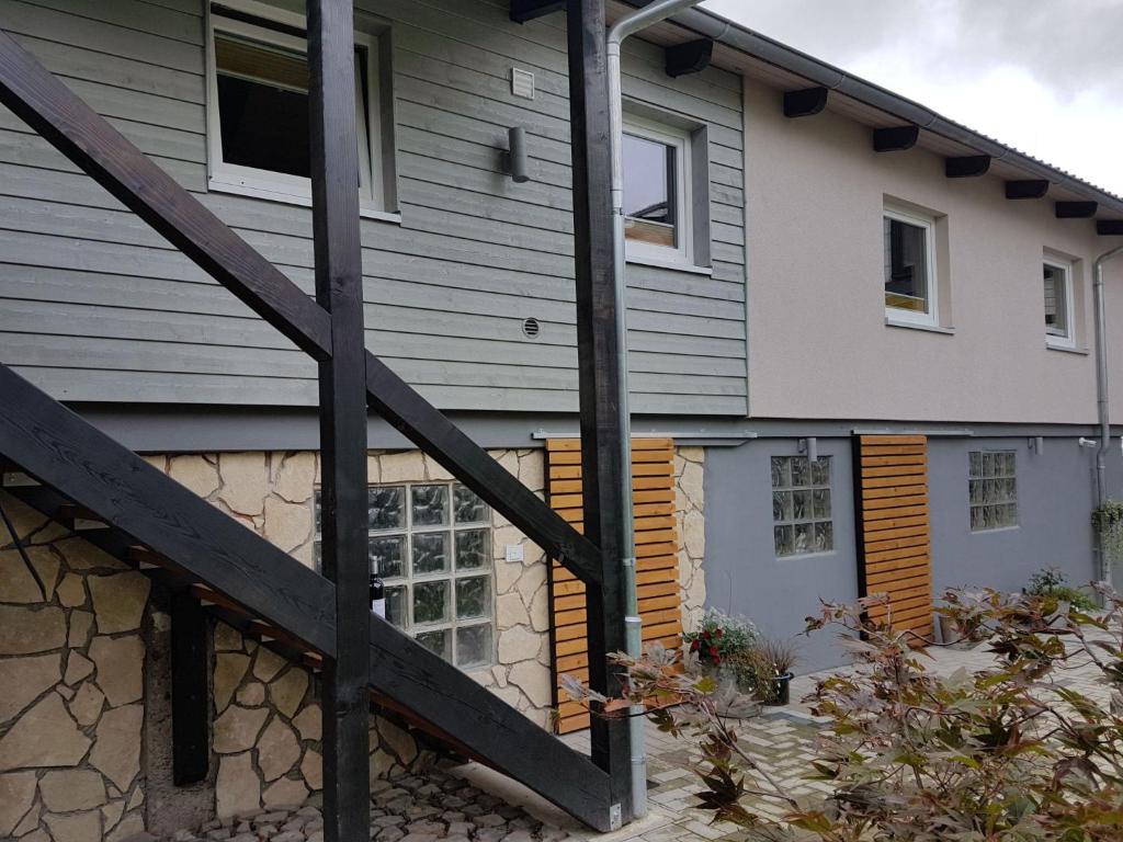 a house with a wooden staircase in front of it at Apartment Mia by Interhome in Fritzlar