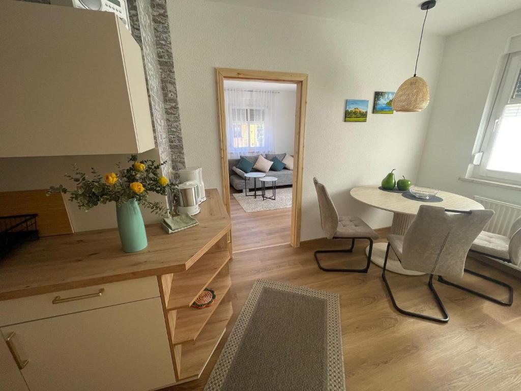 a kitchen and living room with a table and chairs at Apartment Fewo Wilhelm by Interhome in Scholis