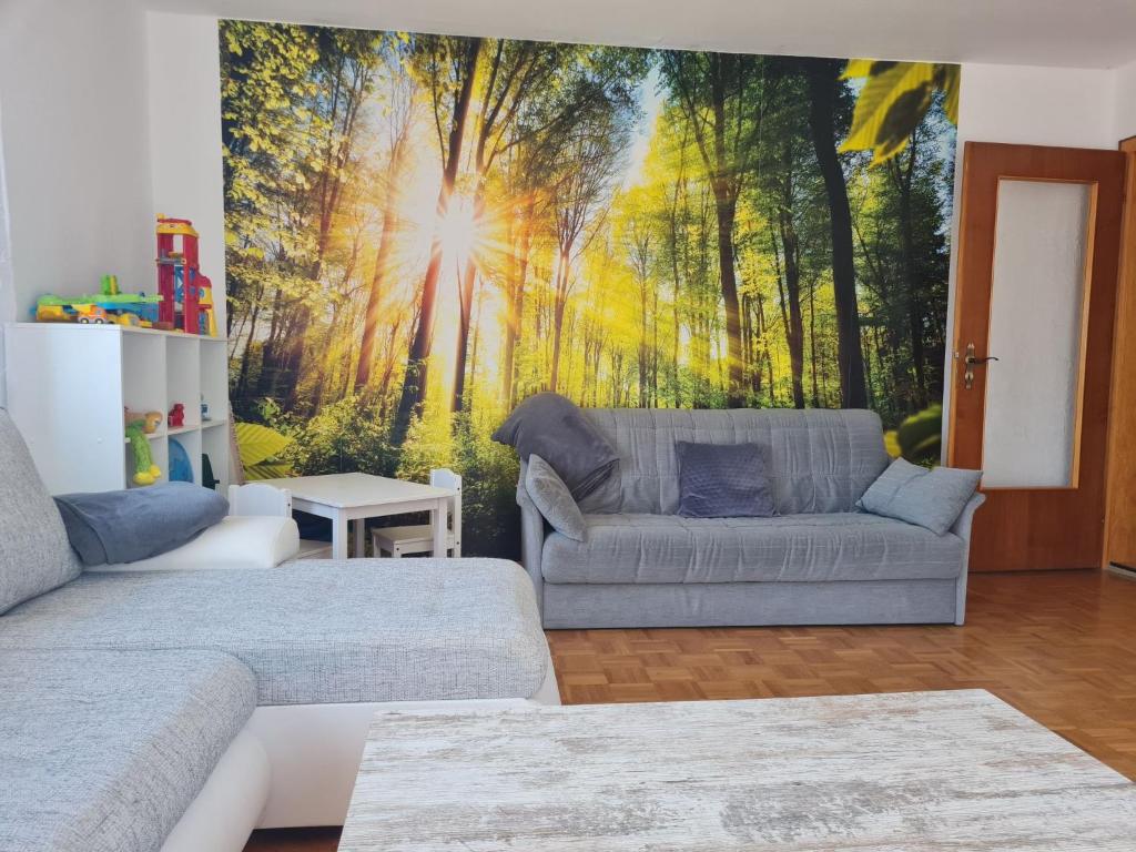 a living room with a mural of a forest at Apartment Lusen by Interhome in Frauenau