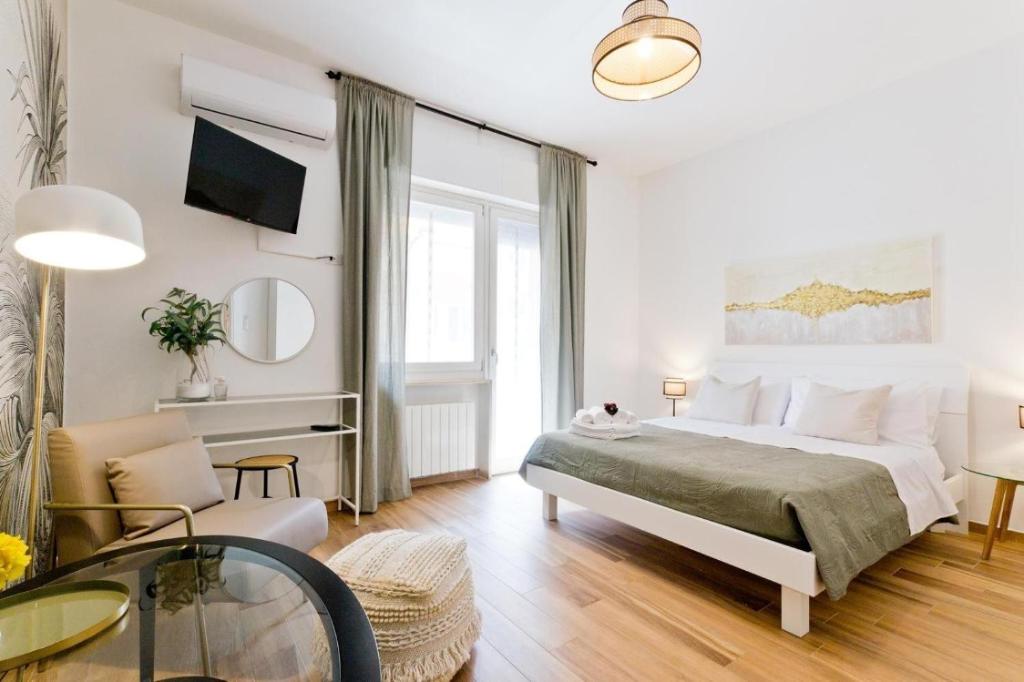 a bedroom with a bed and a living room at Amor Luxury Home in Pescara