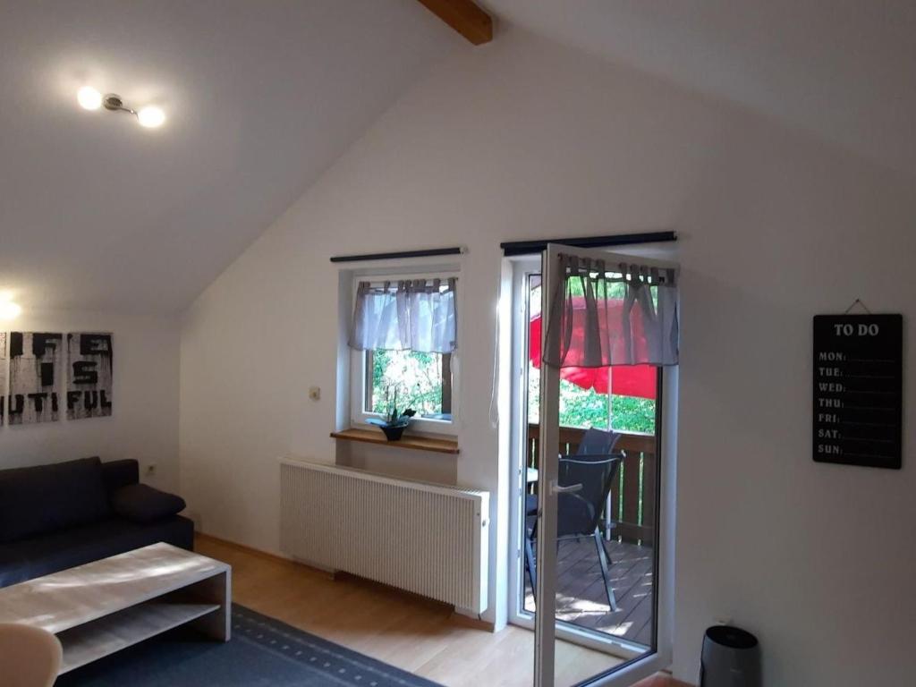 a living room with a couch and a window at Apartment in Berghäuser by Interhome in Grafenwiesen