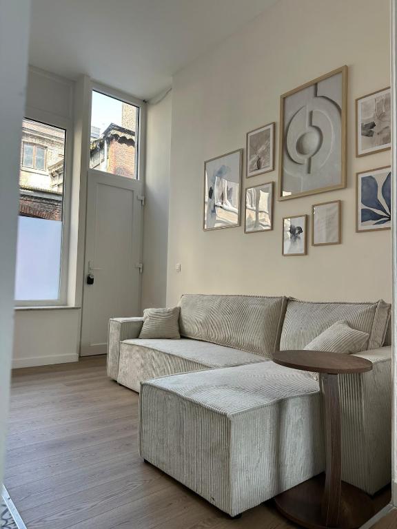 a living room with a couch and a table at Luik city center in Liège