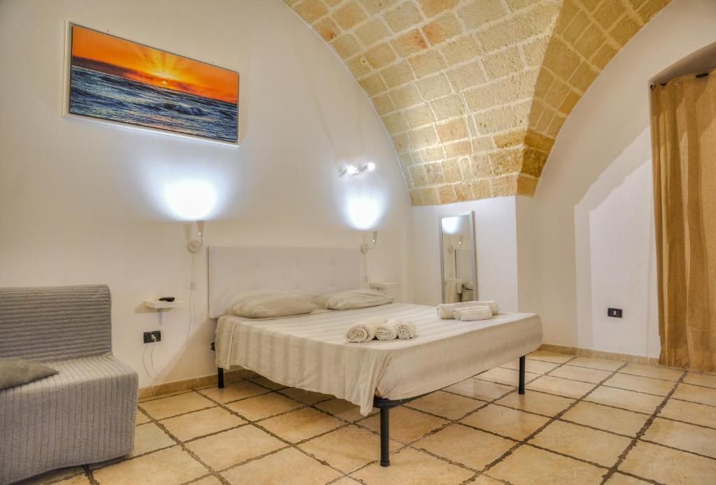 a bedroom with a bed and a couch in a room at History Station in Brindisi
