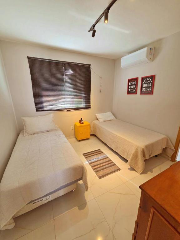 a room with two beds and a window at SaltBeach Salinópolis Salt Reserve in Salinópolis
