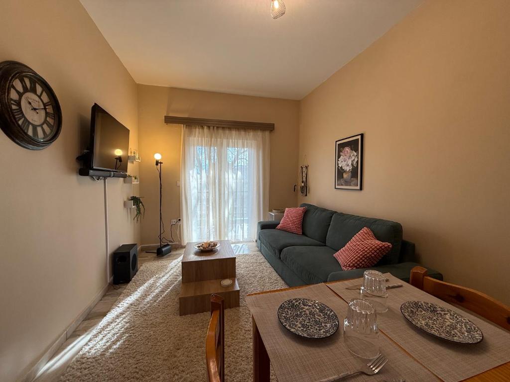 a living room with a couch and a table at Sea&Nature apartment in Aigio