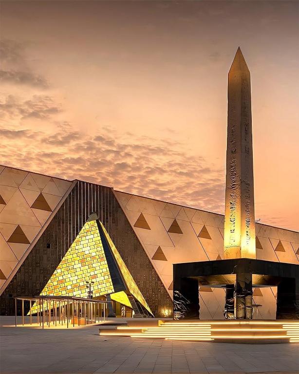 a large building with a obelisk in front of it at Grand Museum Guest House in Kafr Abū ʼumaydah