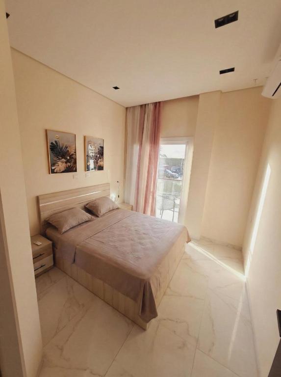 a bedroom with a bed and a window at Jasmine in Sharm El Sheikh