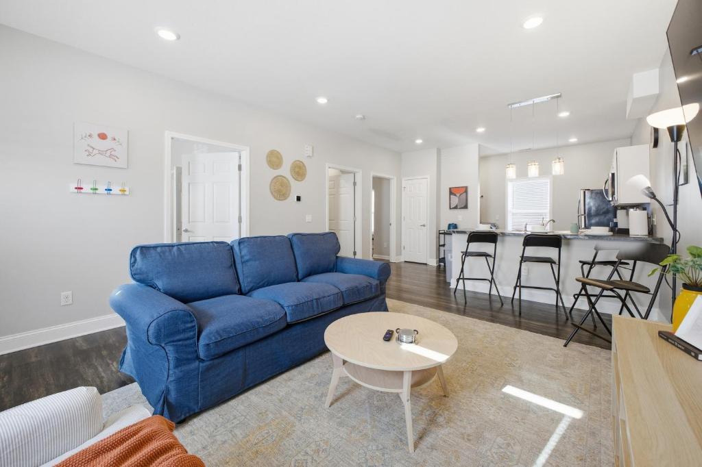 a living room with a blue couch and a table at Sun Valley Courtyard, No Steps in Saint Joseph