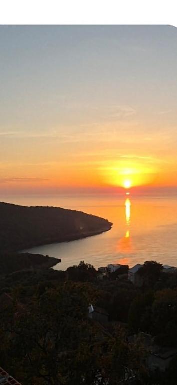 a sunset over a body of water with the sun at BiO Kruce Seaview in Ulcinj
