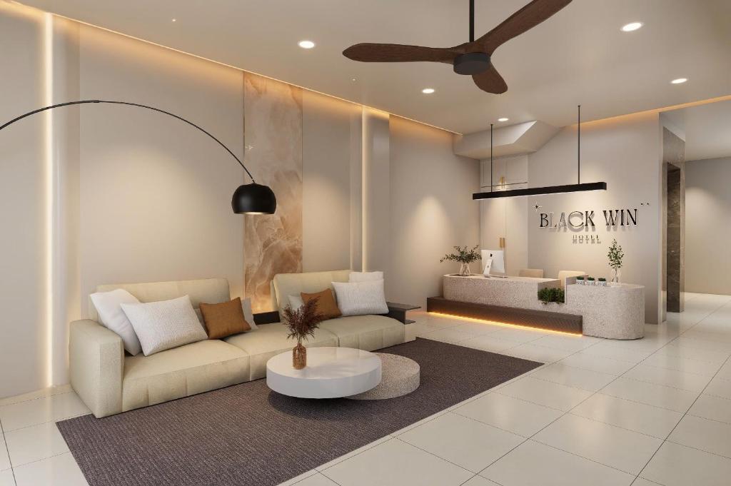 a living room with a couch and a coffee table at Black Win Hotel Phu Yen in Mỹ Hòa (1)