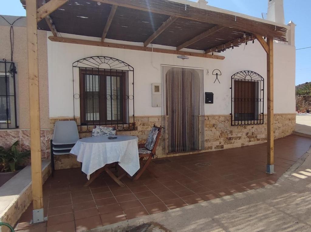 a patio with a table and two chairs on it at La Virgen del Mar in Las Hortichuelas Bajas