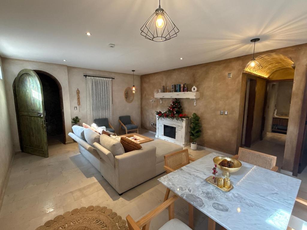 a living room with a couch and a fireplace at Grecia en ValQuirico in Santeagueda