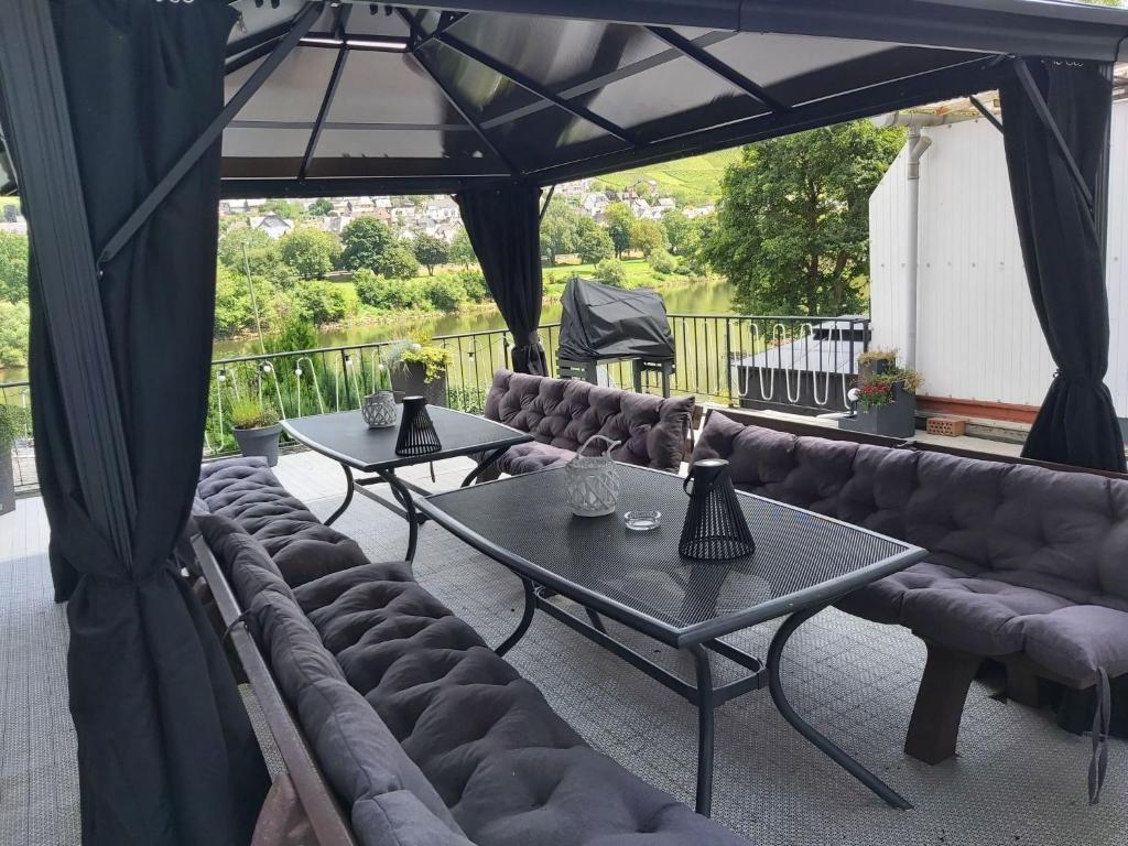 a patio with couches and tables on a deck at Holiday Home L by Interhome in Kövenig