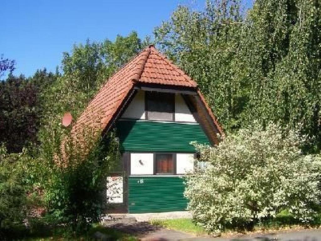 a small green and white house with a roof at Holiday Home Kirschblüte by Interhome in Ronshausen
