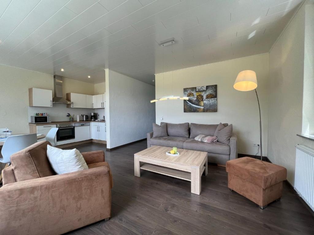 a living room with two couches and a table at Apartment Kommerswag by Interhome in Pittenbach