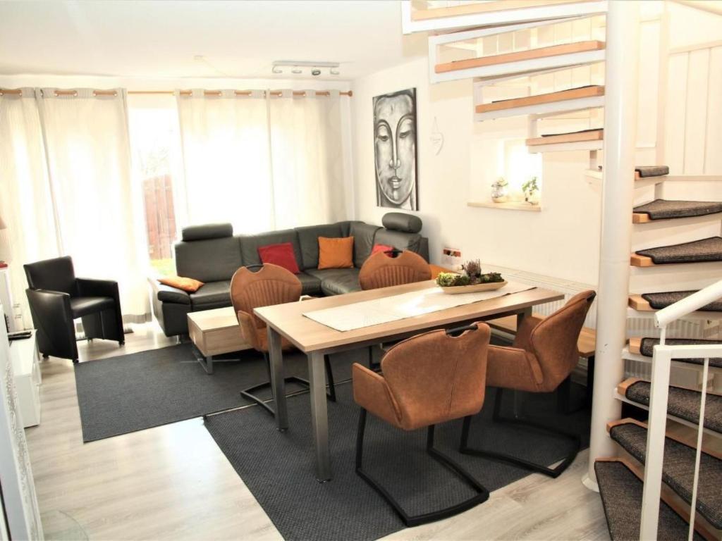 a living room with a table and a couch at Holiday Home Adele - Allergiker geeignet by Interhome in Zandt