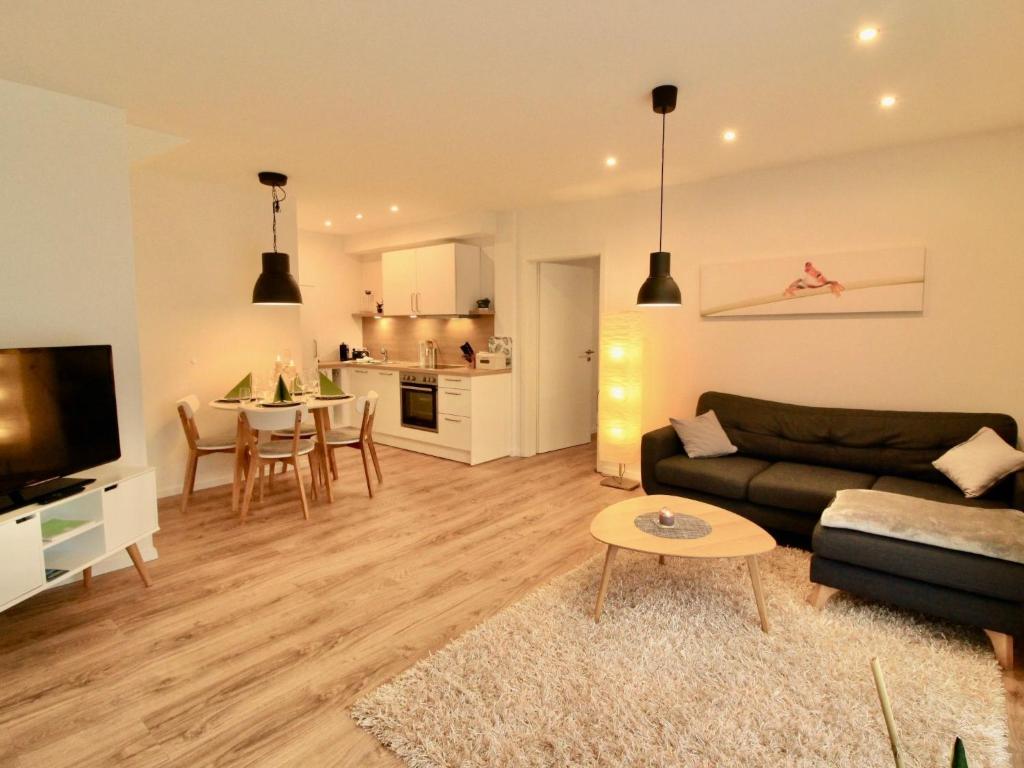 a living room with a couch and a table at Apartment Feldblick by Interhome in Hartheim