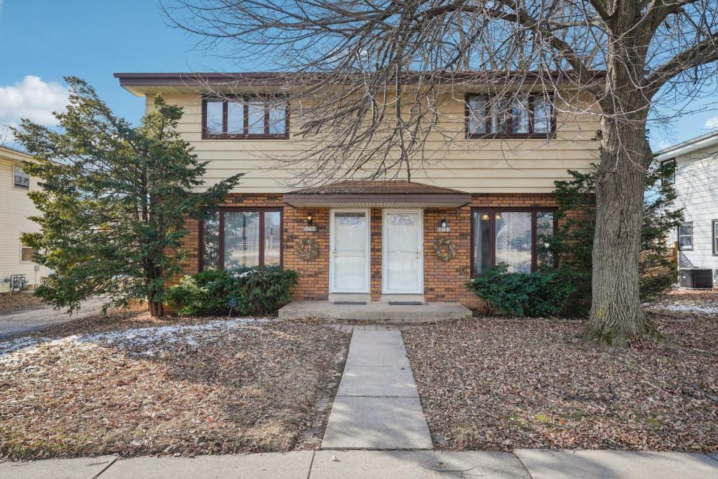 a brick house with a tree in front of it at CBI Haven 1 & 2 in Milwaukee