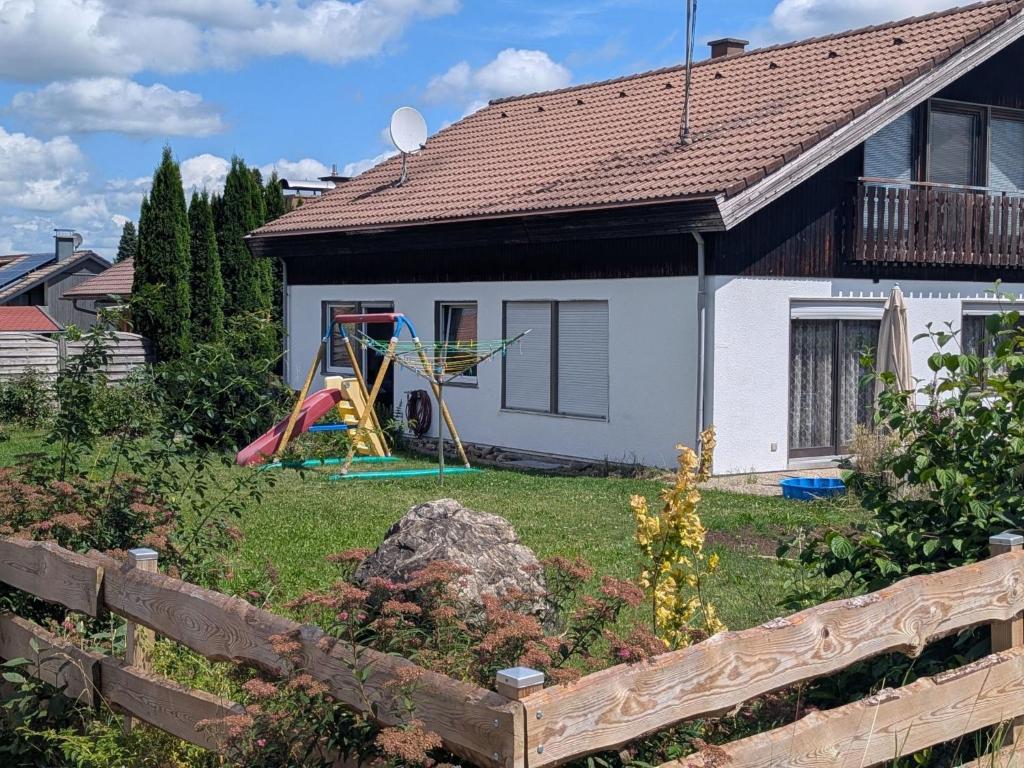 a house with a yard with a playground at Apartment Wittle by Interhome in Weiler-Simmerberg