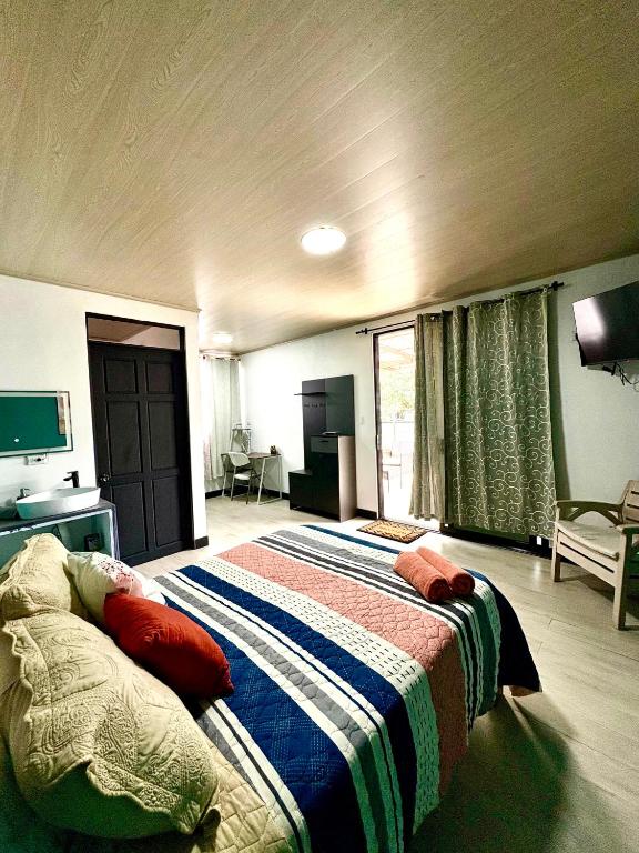 a bedroom with a bed and a television in it at Paraiso En-suite #3 in Parrita