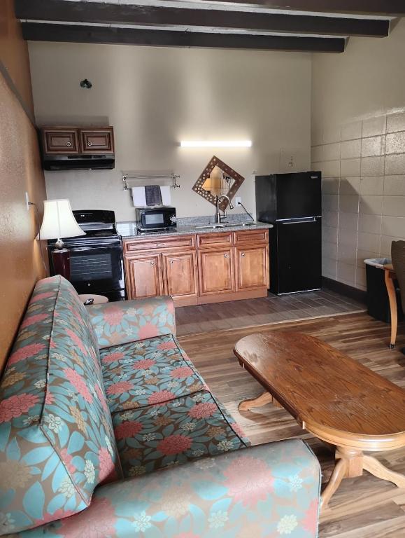 a living room with a couch and a table at Gated 1 King BR1 Bath Apt with Full Kitchen 124 in Baton Rouge